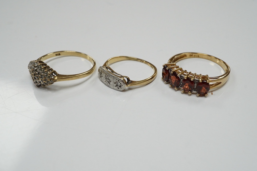 Three assorted 9ct and gem set rings, including three stone diamond, diamond chip cluster and garnet and diamond half hoop, gross weight 6.3 grams. Condition - fair